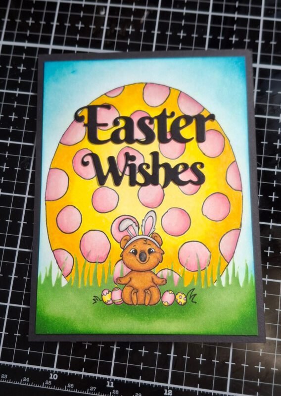 "Easter Wishes" was die cut from black cardstock and the colored panel was trimmed and matted on black cardstock