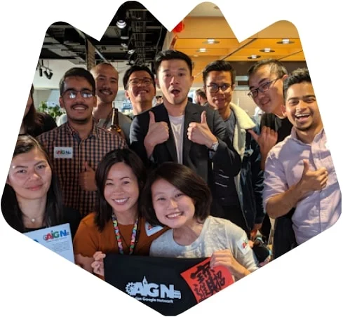 A group of Asian Googlers smile at the camera