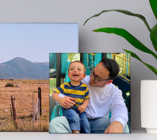 A photo canvas print featuring a father and son embracing and laughing.