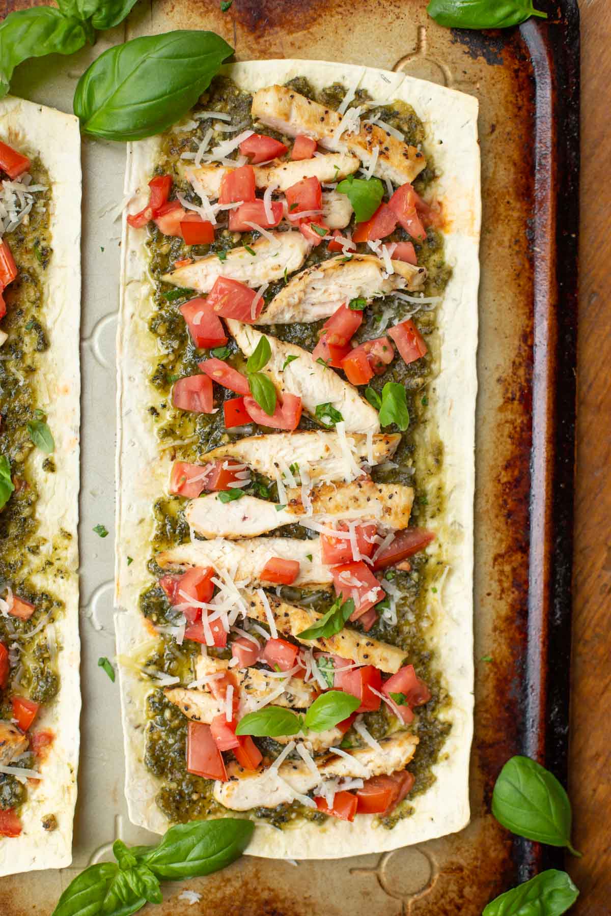 Try making either of these Healthy Flatbread Pizzas! Chicken Pesto Pizza and Buffalo Chicken pizza - BOTH full of flavor and low on calories! Flatout flatbread pizza with pesto chicken and fresh tomatoes