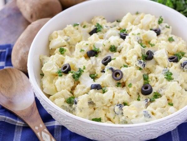 A best potato salad recipe topped with sliced olives.