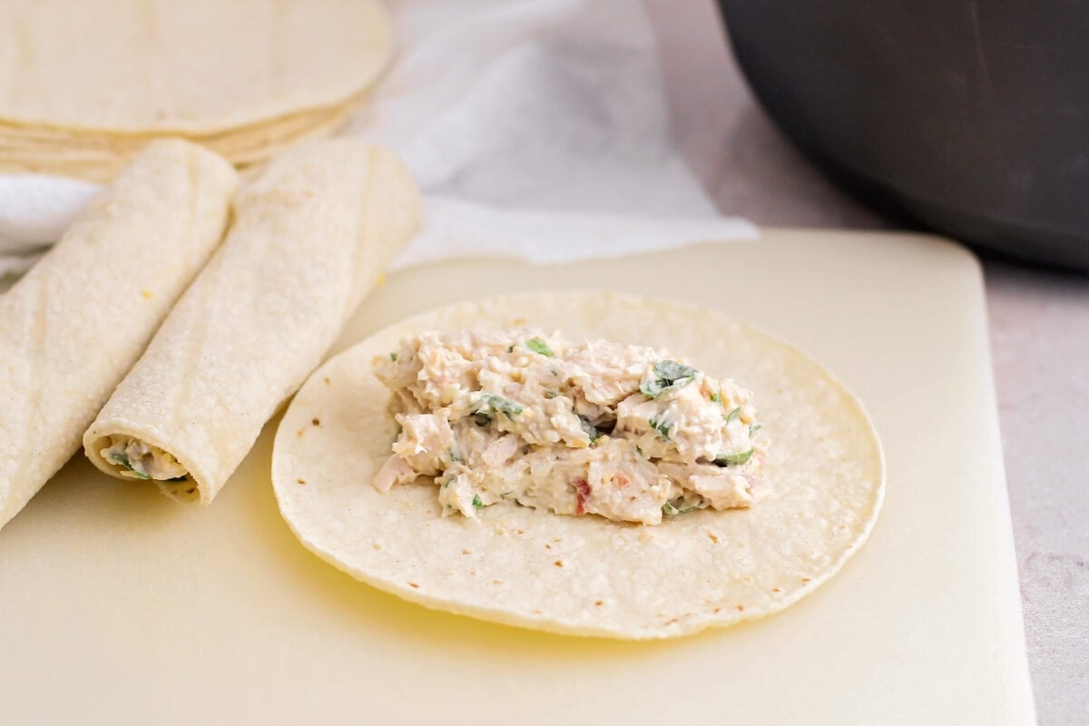 Filling added to corn tortillas for homemade flautas recipe.