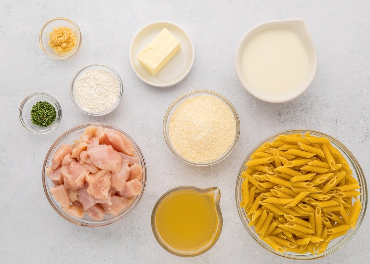 Creamy, cheesy, and ready in 30 minutes, this classic chicken penne pasta is the ultimate weeknight comfort food. Ingredients for chicken penne pasta on a kitchen counter.