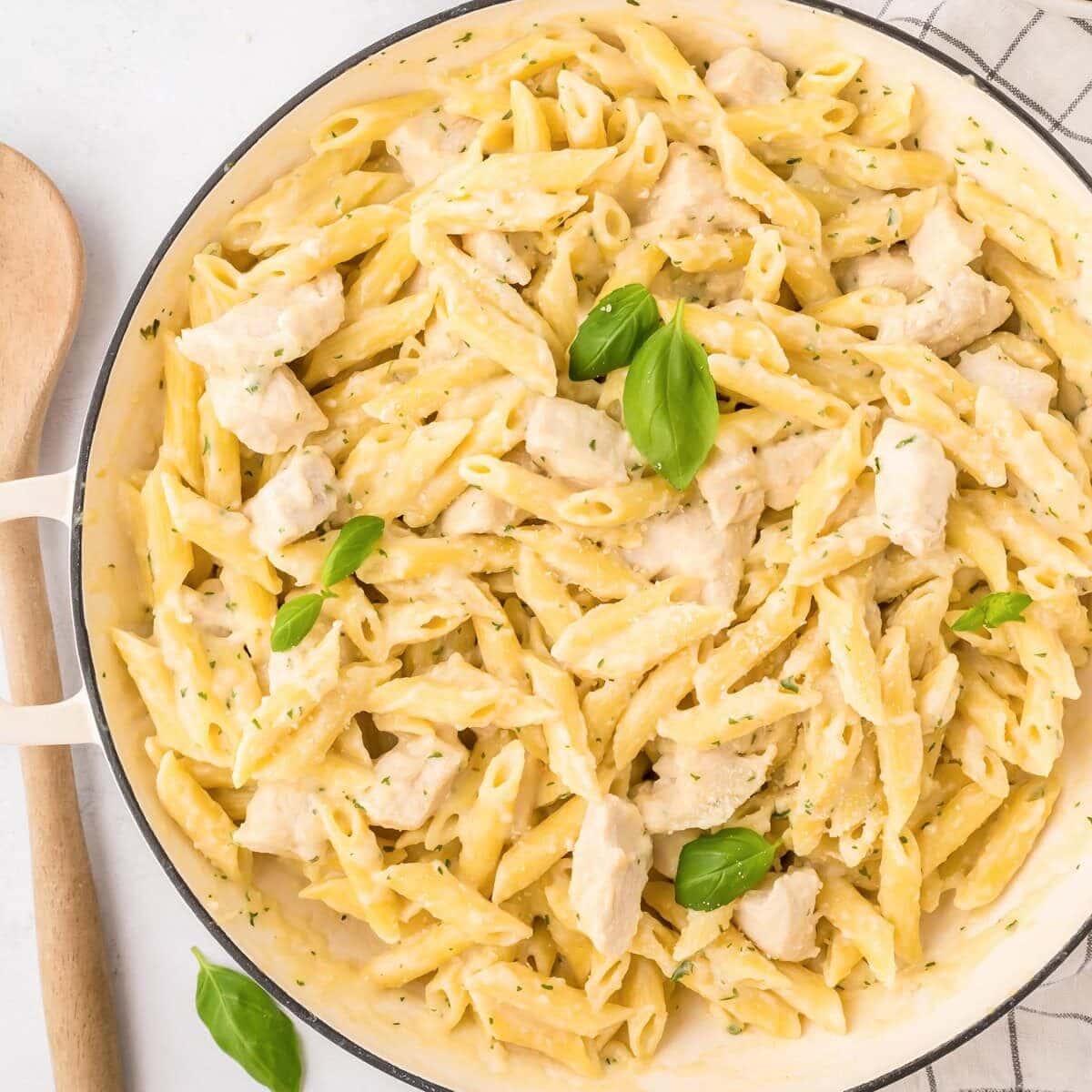 Creamy, cheesy, and ready in 30 minutes, this classic chicken penne pasta is the ultimate weeknight comfort food. Close up image of chicken penne pasta in bowl.