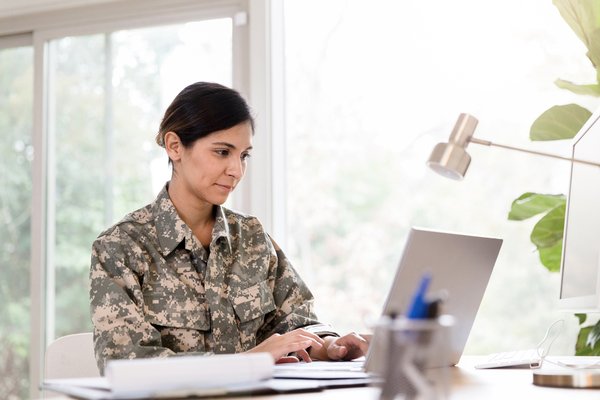 Soldier typing on their laptop.