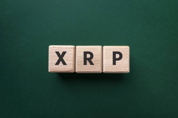 Wooden blocks that spell out XRP, which is the Ripple cryptocurrency.