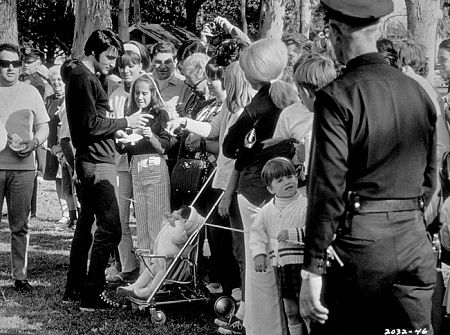 Elvis Presley signing autographs during a break from filming  "Change of Habit," Universal, 1969.