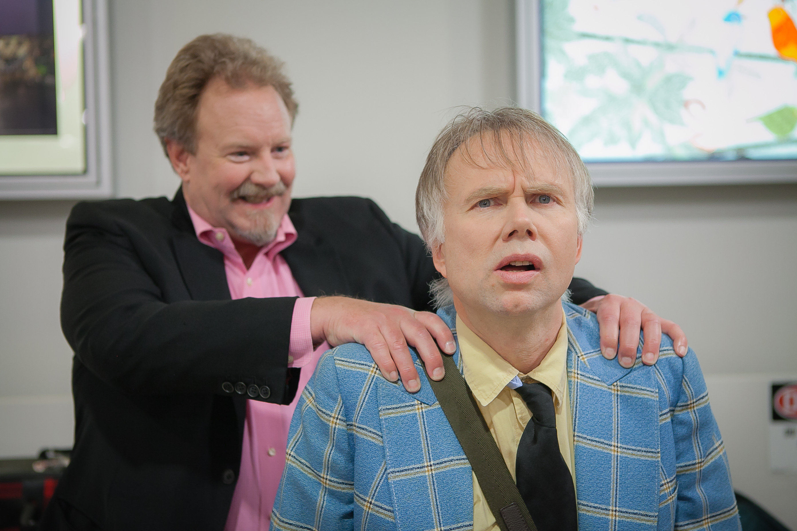 Dunc (actor Robert David Duncan) sneaks up on Mitch (actor Ross Munro) at the airport. 