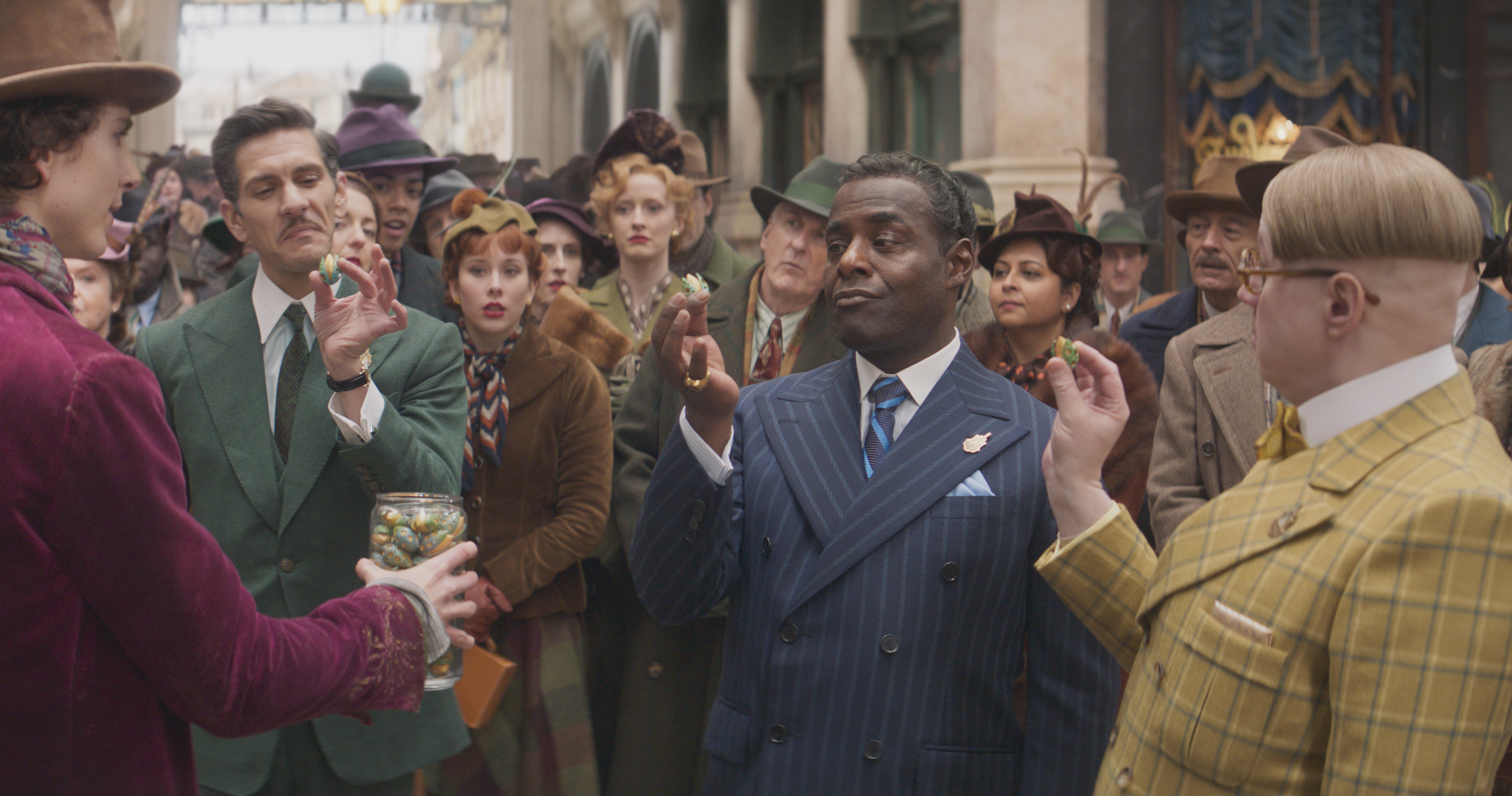 Paterson Joseph, Matt Lucas, Gianni Calchetti, Hayden Ellingworth, Malcolm J K Baker, Edward Terry, Mathew Baynton, Timothée Chalamet, Richard Price, and Nick Owenford in Wonka (2023)