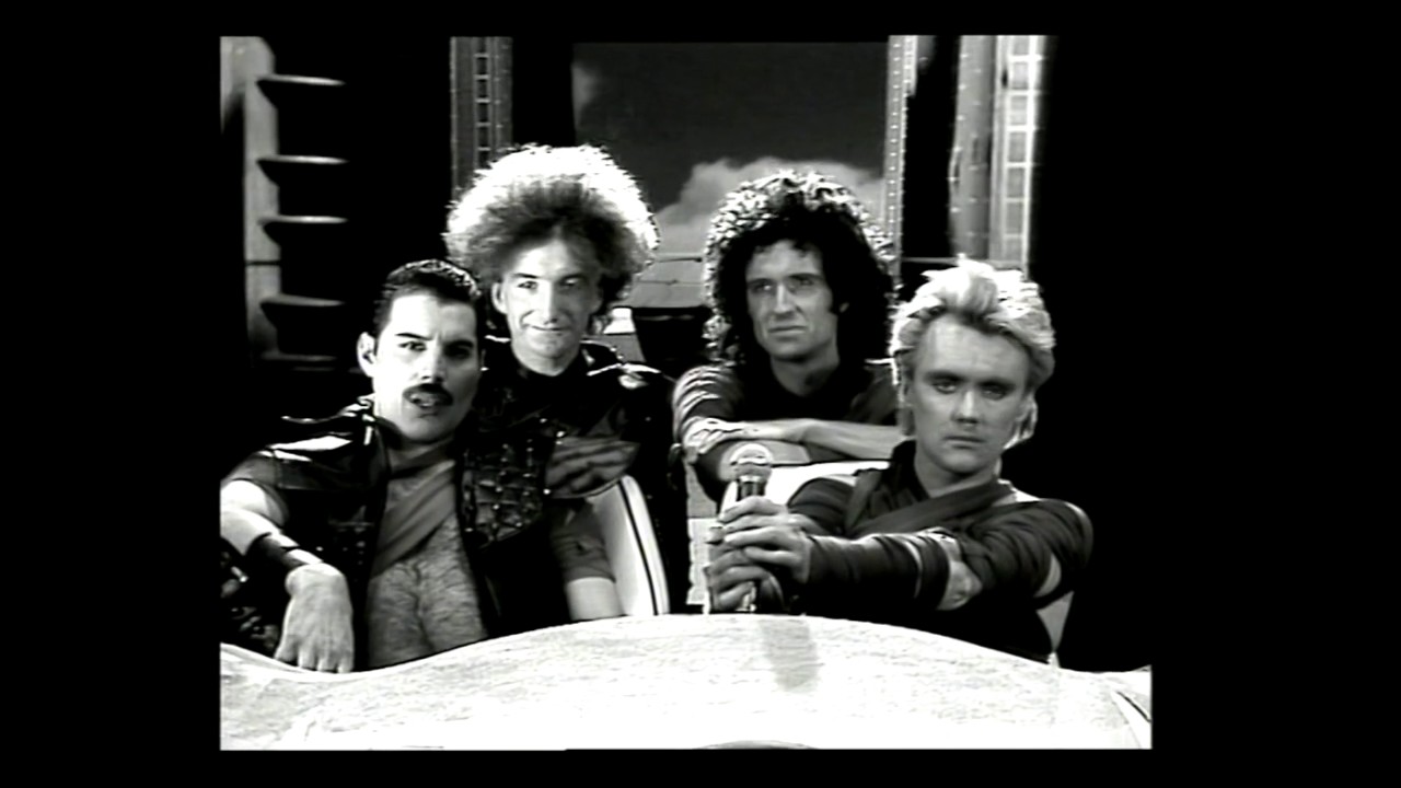 Roger Taylor, Brian May, Freddie Mercury, John Deacon, and Queen in Queen: Radio Ga Ga (1984)