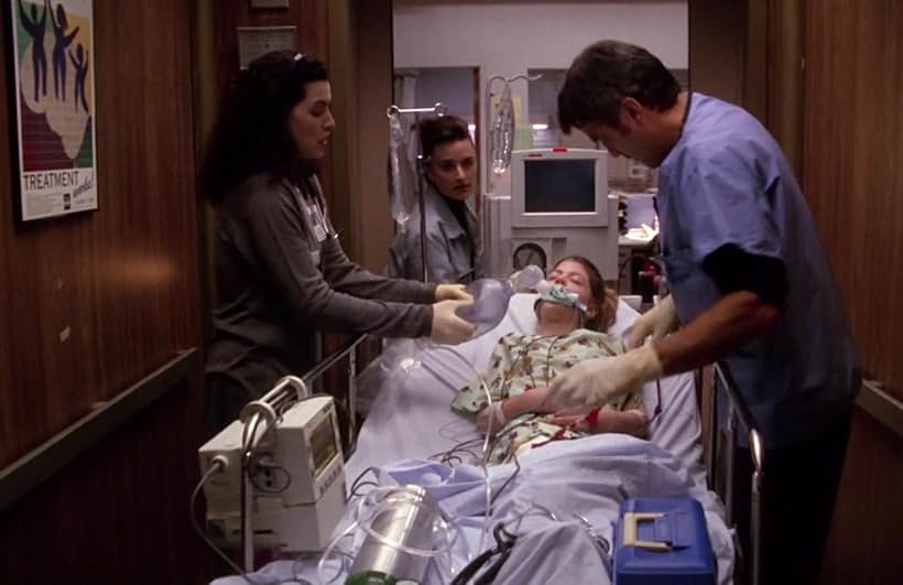 George Clooney, Julianna Margulies, Kelsey Mulrooney, and Kyle Richards in ER (1994)