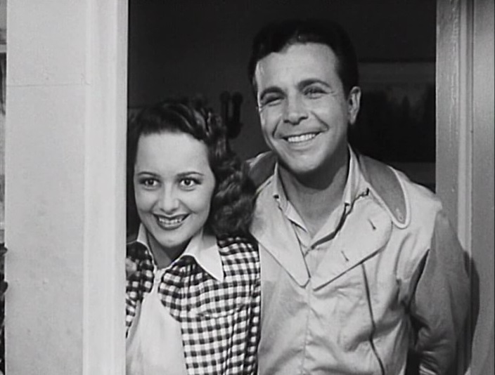 Olivia de Havilland and Dick Powell in Hard to Get (1938)