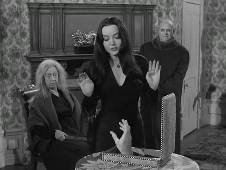 Jackie Coogan, Marie Blake, Carolyn Jones, and Thing in The Addams Family (1964)