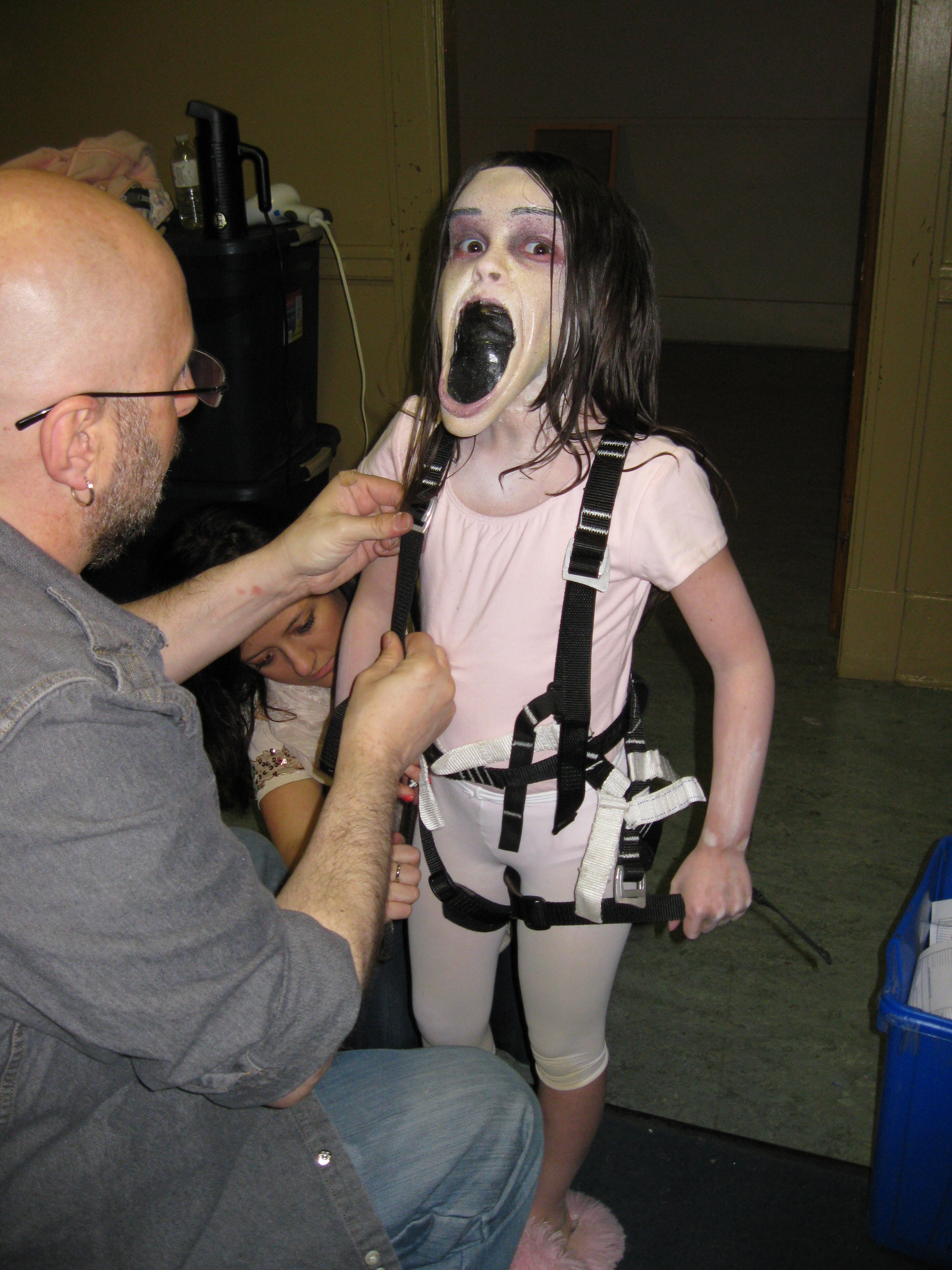 Dalila Bela putting the harness for one of her scenes on "Grave Encounters 2"