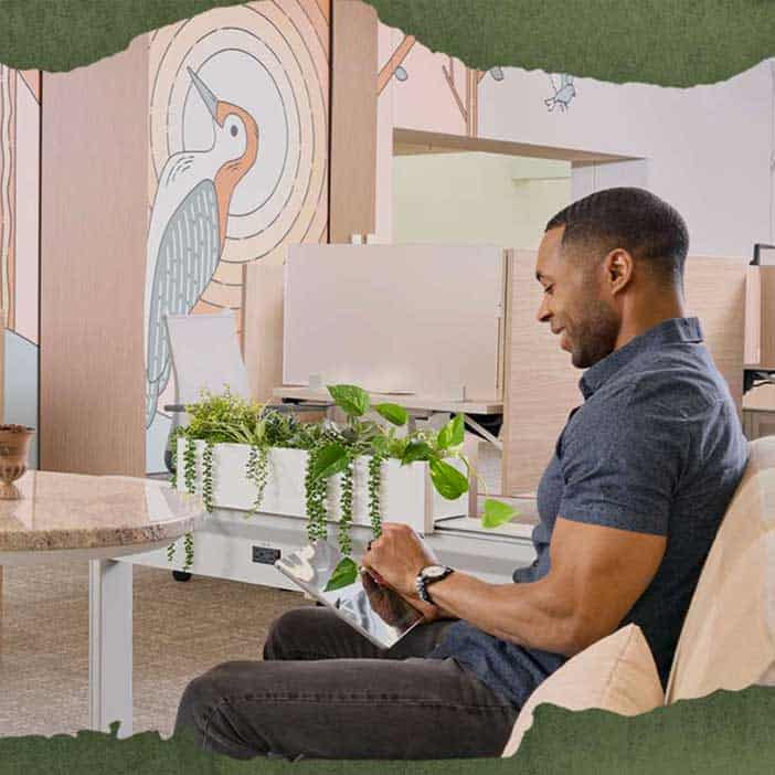 A man works on an iPad in a spacious room