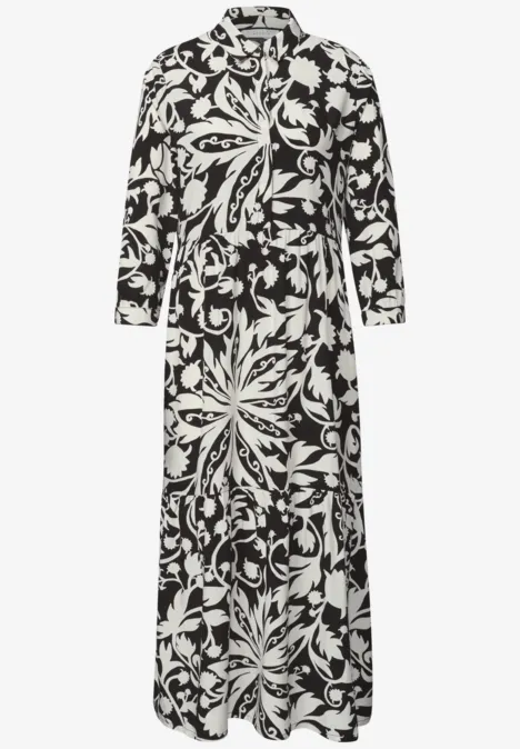 Midi-jurk met volants en bloemenpatroon Black Zwart-witte, lange jurk met lange mouwen, opvallende bloemenprint en getailleerde pasvorm.