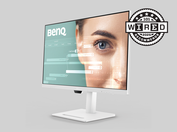 A white computer monitor showing someones face