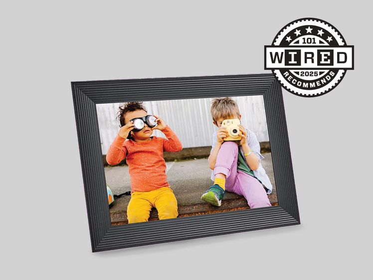 A black digital picture frame with photographs of two children