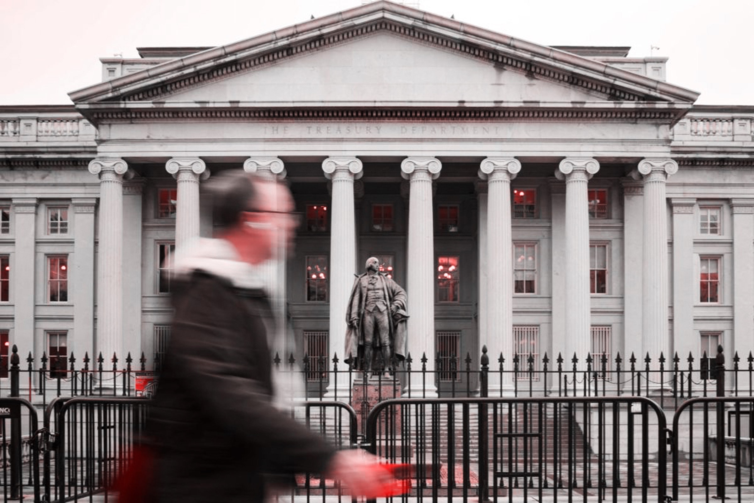 a person walking past the US Treasury building