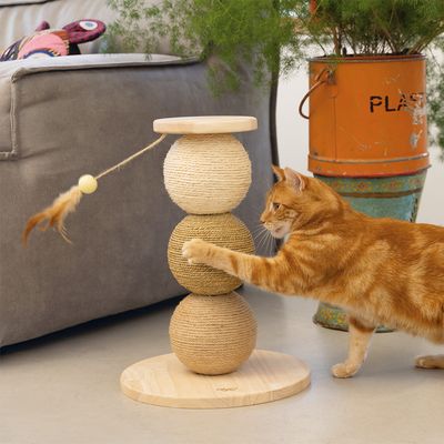 Cat scratching toy made of wood and sisal with three balls, feather pendant. Cat interacting with the toy.