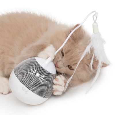 Zabawka Catit z piórkiem i okrągłym designem, beżowy kot się bawi.