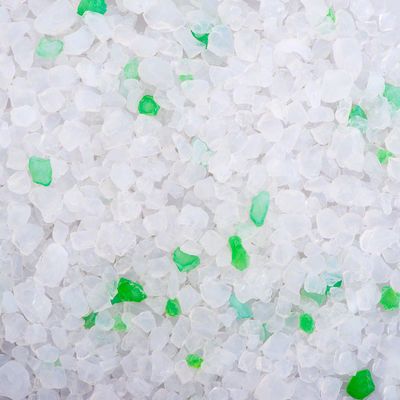 Close-up of white and green silica crystals, possibly cat litter.