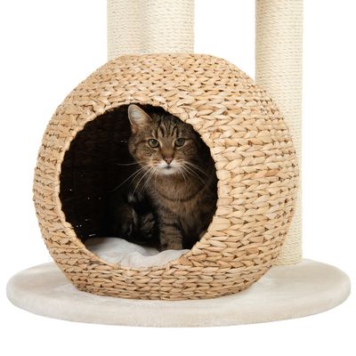 Cat cave made of woven natural material with soft padding, part of a scratching post. Cat is sitting in the cave.