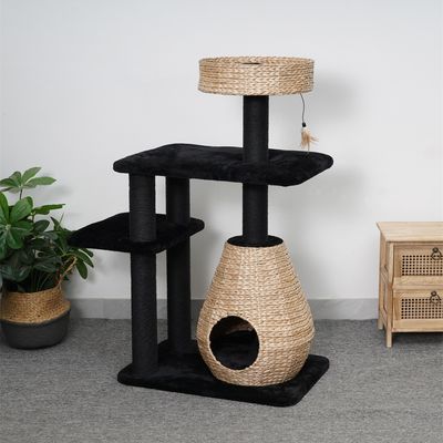 Cat tree made of black fabric and woven natural material with cave, two platforms and toy pendant.