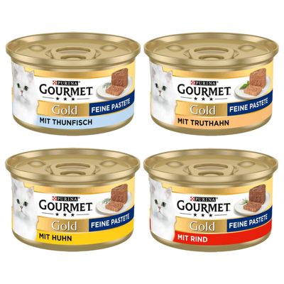 Purina Gourmet Gold paté fino con pollo, 48 latas. Se muestra: lata dorada con motivo de gato y trozo de paté en plato.