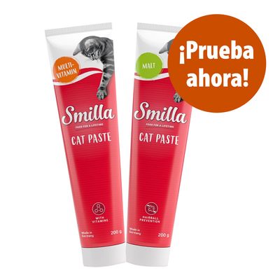 Dos tubos de Smilla Cat Paste, uno Multivitamin y otro Malt, 200 g cada uno. Texto visible: '¡Prueba ahora!'. Indicaciones en inglés sobre vitaminas y prevención de bolas de pelo.