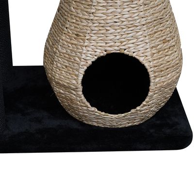 Woven basket made of natural material with round entrance, placed on a black base.