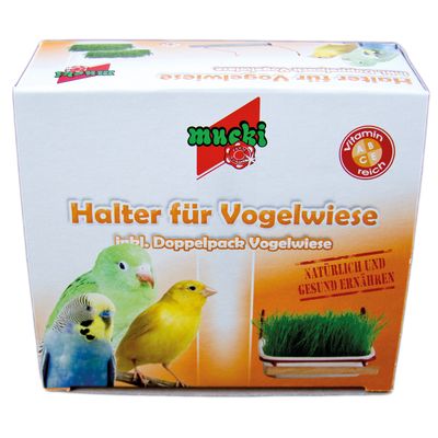 Caja de soporte para césped para aves, marca mucki. Texto visible en alemán: Halter für Vogelwiese, inkl. Doppelpack Vogelwiese, Vitamin A B C reich, natürlich und gesund ernähren.