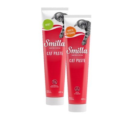 Dos tubos de Smilla Cat Paste, uno Multivitamin y otro Malt, 200 g cada uno. Texto visible: '¡Prueba ahora!'. Indicaciones en inglés sobre vitaminas y prevención de bolas de pelo.