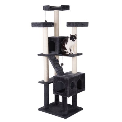Cat tree with multiple levels, caves and sisal posts. Black and white cat sitting on a platform. Toy pendant visible.