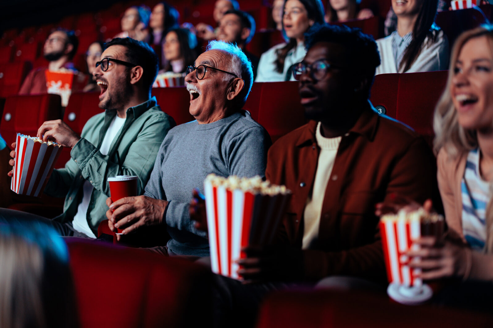 Diverse friends in movie theater.