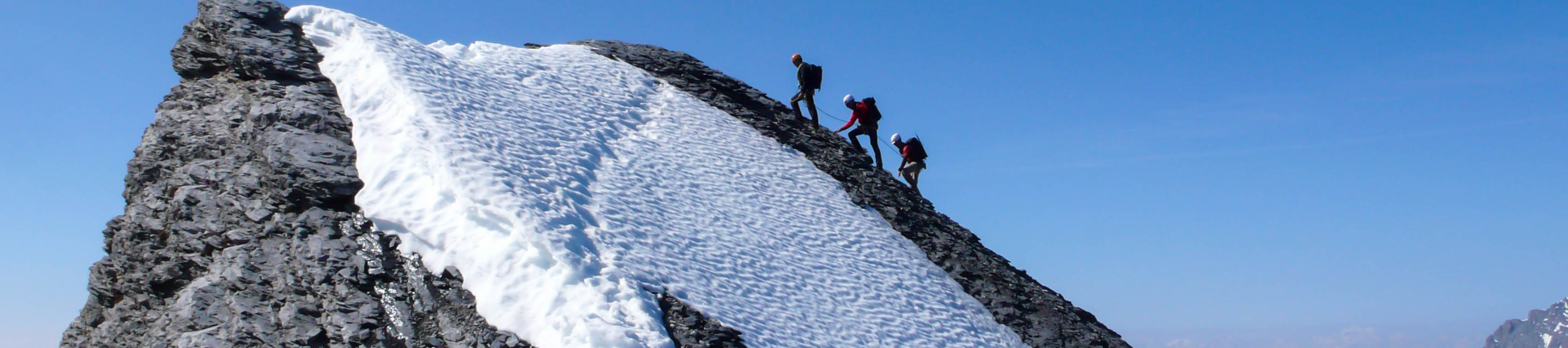 Hikers climbing to the top of the mountain