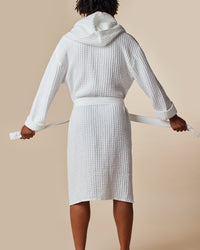  The back view of a man modeling the ONSEN White Waffle Bath Robe.