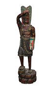 American Cigar Store Indian, 62" H x 15"w (age splits, Peeling Paint): American Cigar Store Indian, 62" H x 15"w (age splits, Peeling Paint)