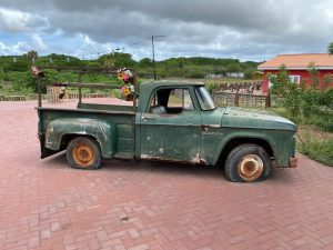 An old green Dodge pick-up with flat tires at the farm of Hofi Cas Cora on the island of Curaçao.
