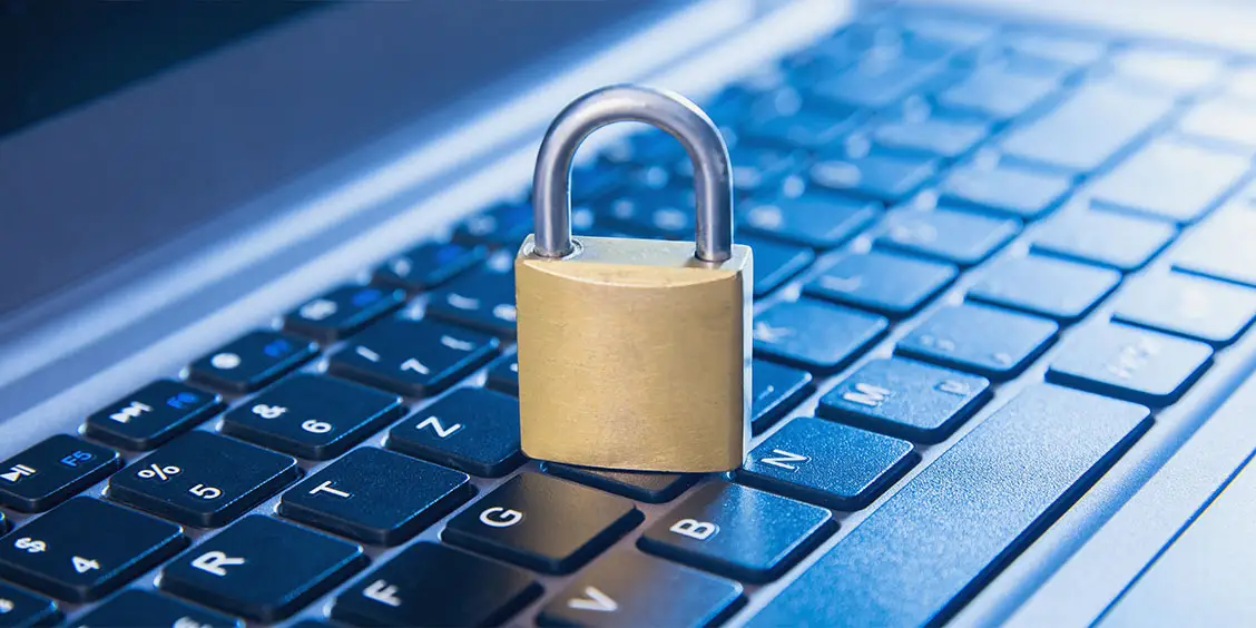 Padlock on a laptop keyboard, symbolizing IT security and data protection for maintenance support services.