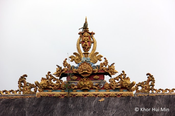 Beautiful carved ornamented atop one of the temple roofs