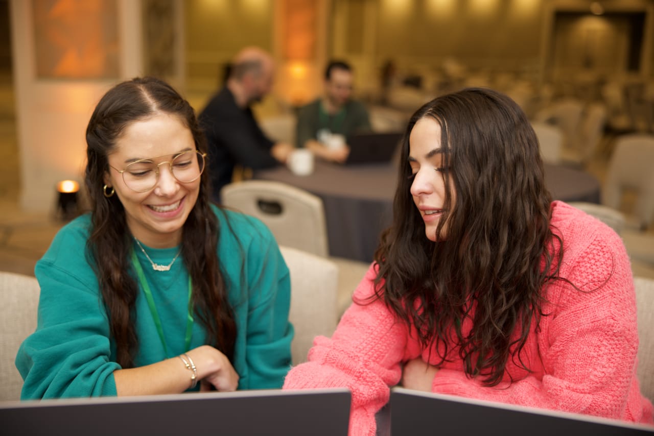 Two Zapier employees looking at a laptop