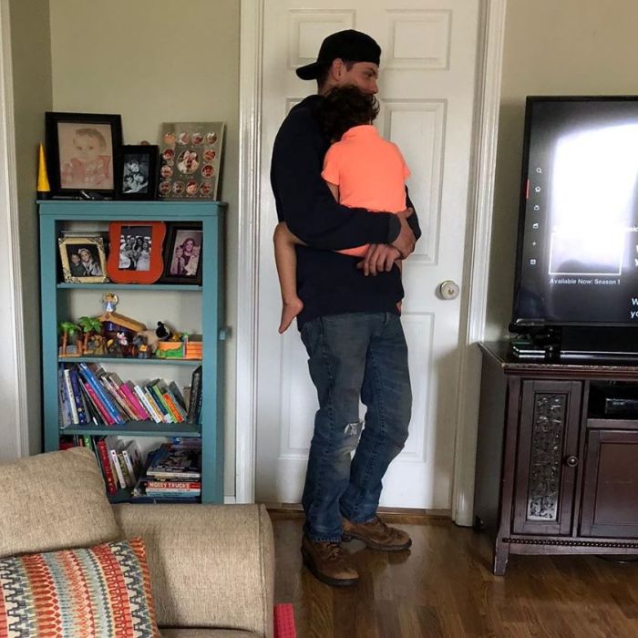Calbe man holding customer's son.