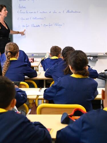 Pupils of Les Bordes primary school listen to their teacher at the start of the new school year in Metz, northeastern France, on September 2, 2024.