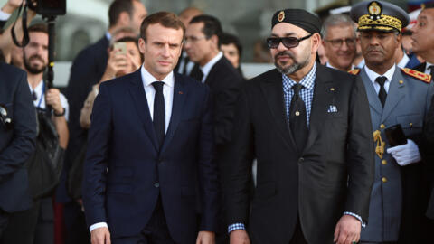 French President Emmanuel Macron (C-L) arrives with Morocco's King Mohammed VI (C-R) at the Rabat Agdal train station for the inauguration of a high-speed railway line on November 15, 2018. 