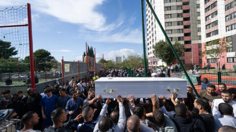 People hold the coffin of Nessim Ramdane during a ceremony at the Mediterranean mosque (mosquee de la Mediterranee) in Marseille, southern France, on October 8, 2024.