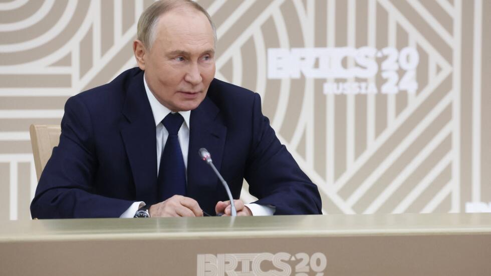 In this pool photograph distributed by the Russian state agency Sputnik, Russia's President Vladimir Putin meets media outlets from the BRICS member countries in Moscow on October 18, 2024.