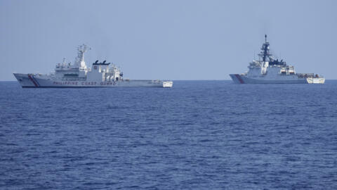 A U.S. Coast Guard Cutter Stratton (WMSL 752), right, beside Philippine Coast Guard ship Melchora Aquino during a trilateral Coast Guard drill off the waters in Bataan province, Philippines, Tuesday,