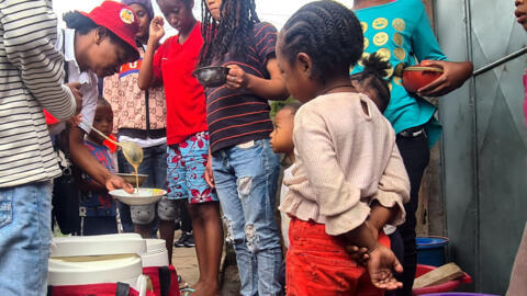 Local vendor Tantely distributes Koba Aina, a fortified porridge, to families in a disadvantaged area of Madagascar's capital, Antananarivo.