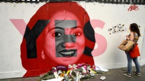 A woman looks at a new mural of Savita Halappanavar with flowers placed beneath it put up on the day of the Abortion Referendum on liberalising abortion laws in Dublin, Ireland May 25, 2018.